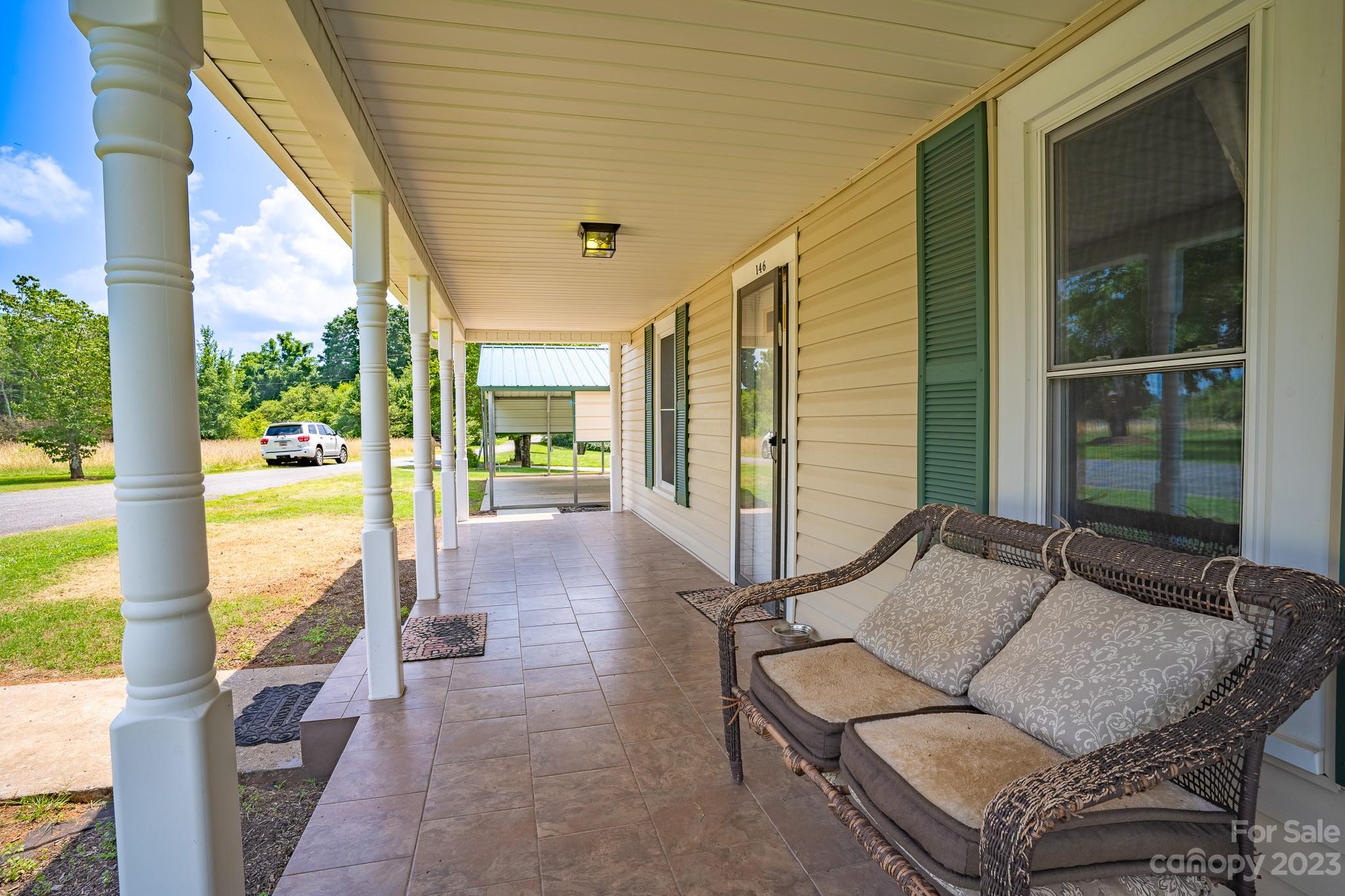 146 Sorrells Road Rutherfordton, NC 28139 - Photo 2 of 25 a outdoor space with patio the couch and glass door