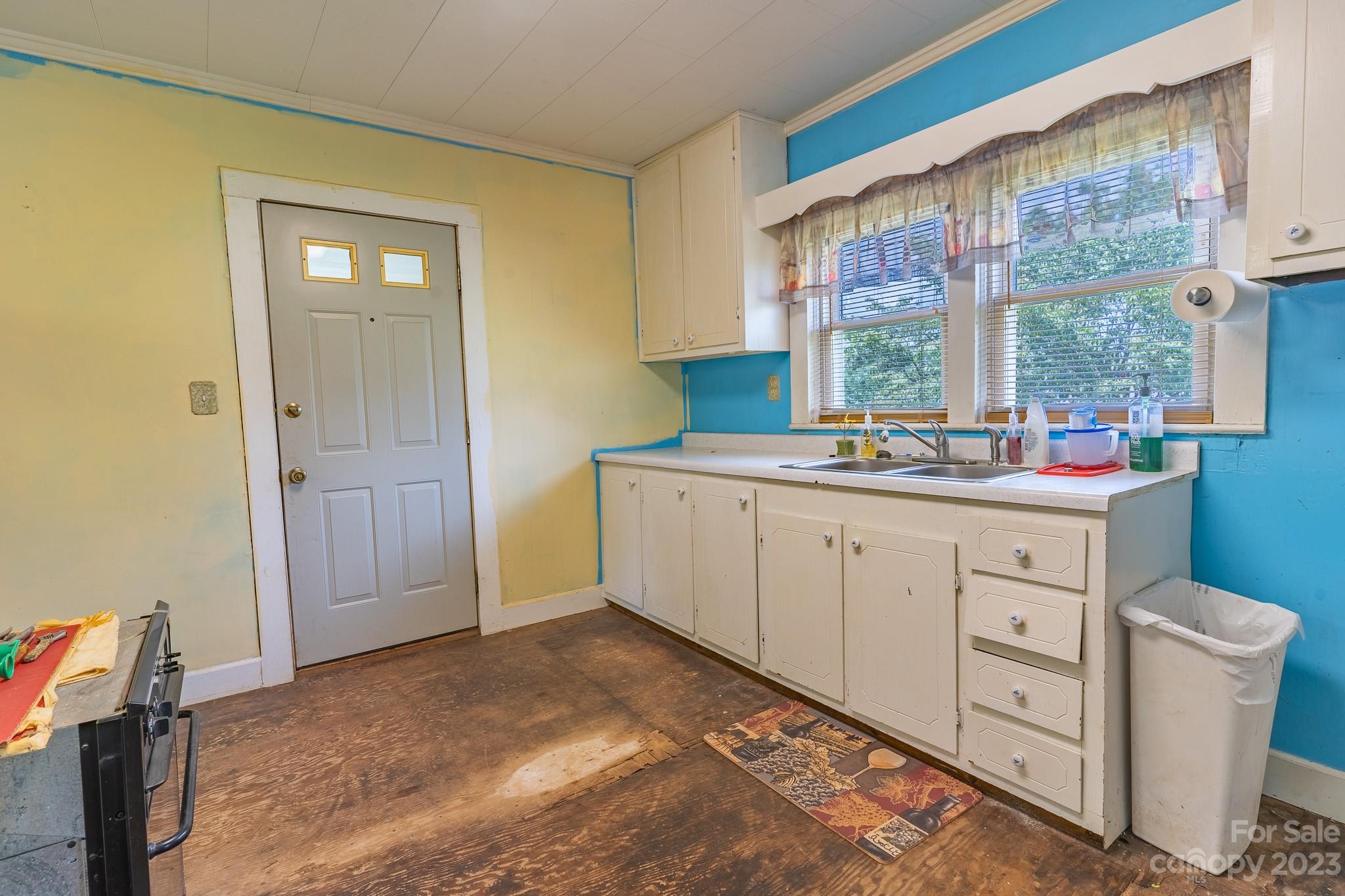 146 Sorrells Road Rutherfordton, NC 28139 - Photo 6 of 25 a kitchen with a sink window and cabinets