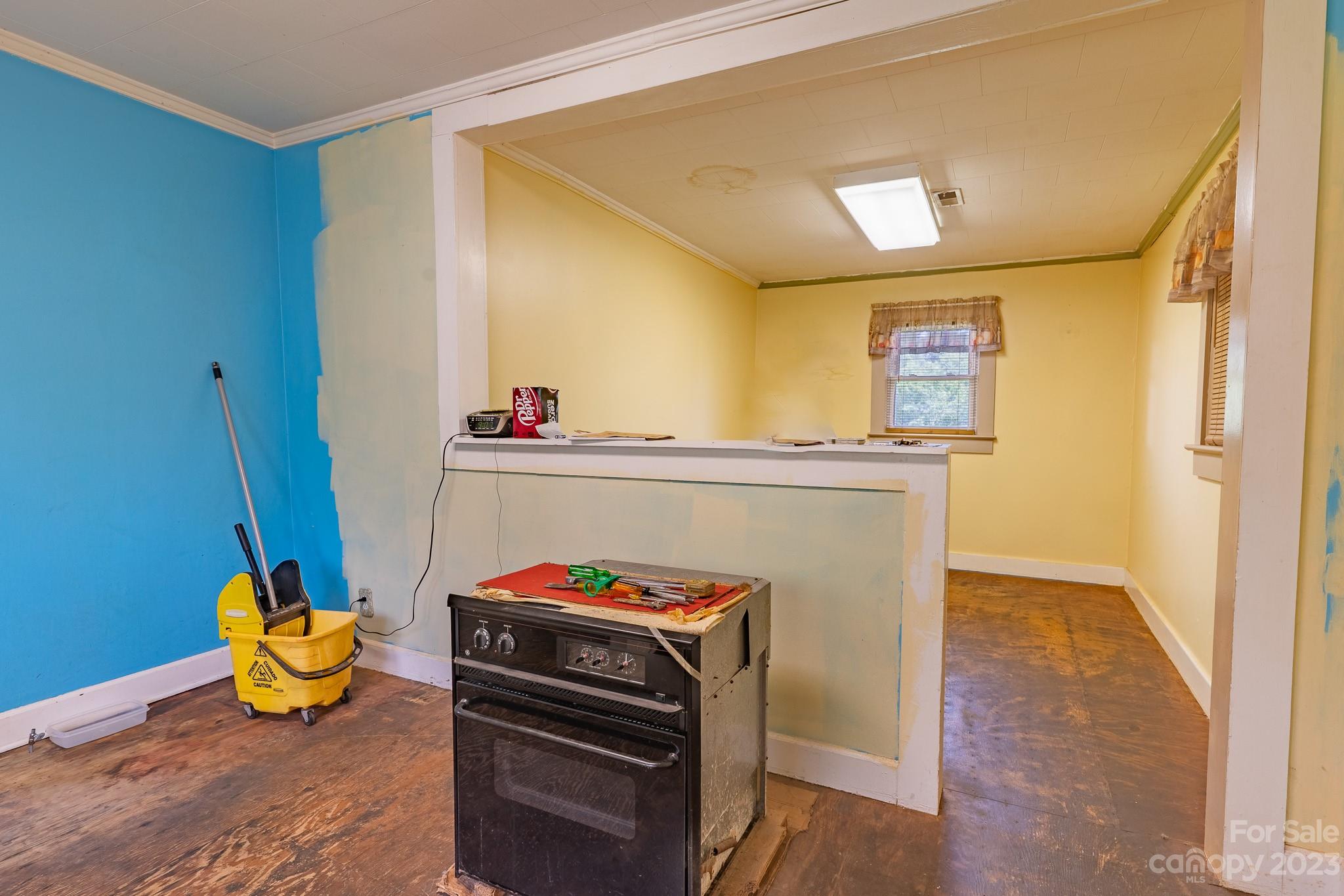 146 Sorrells Road Rutherfordton, NC 28139 - Photo 8 of 25 a kitchen with a stove and a wooden floor