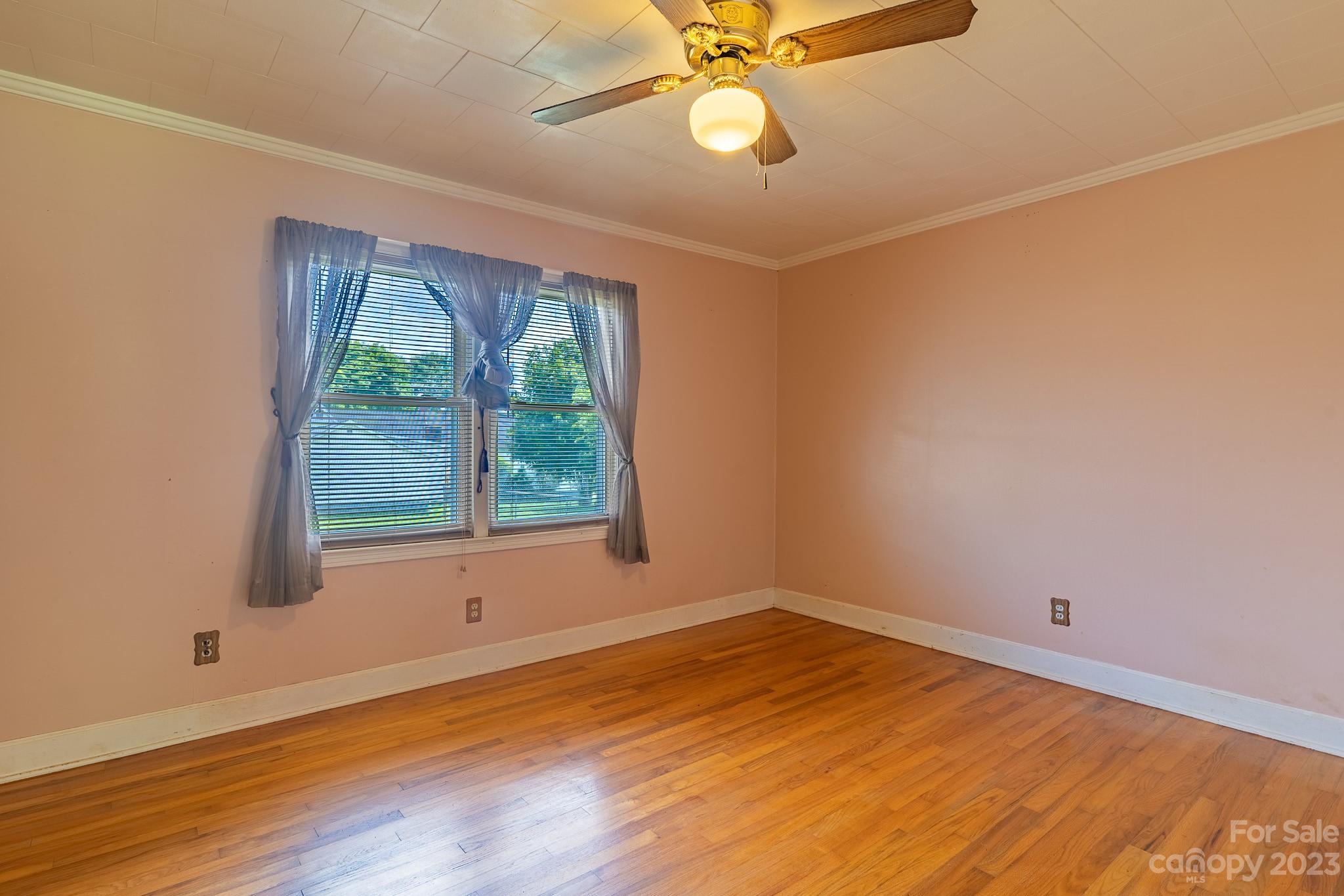 146 Sorrells Road Rutherfordton, NC 28139 - Photo 10 of 25 an empty room with wooden floor and windows