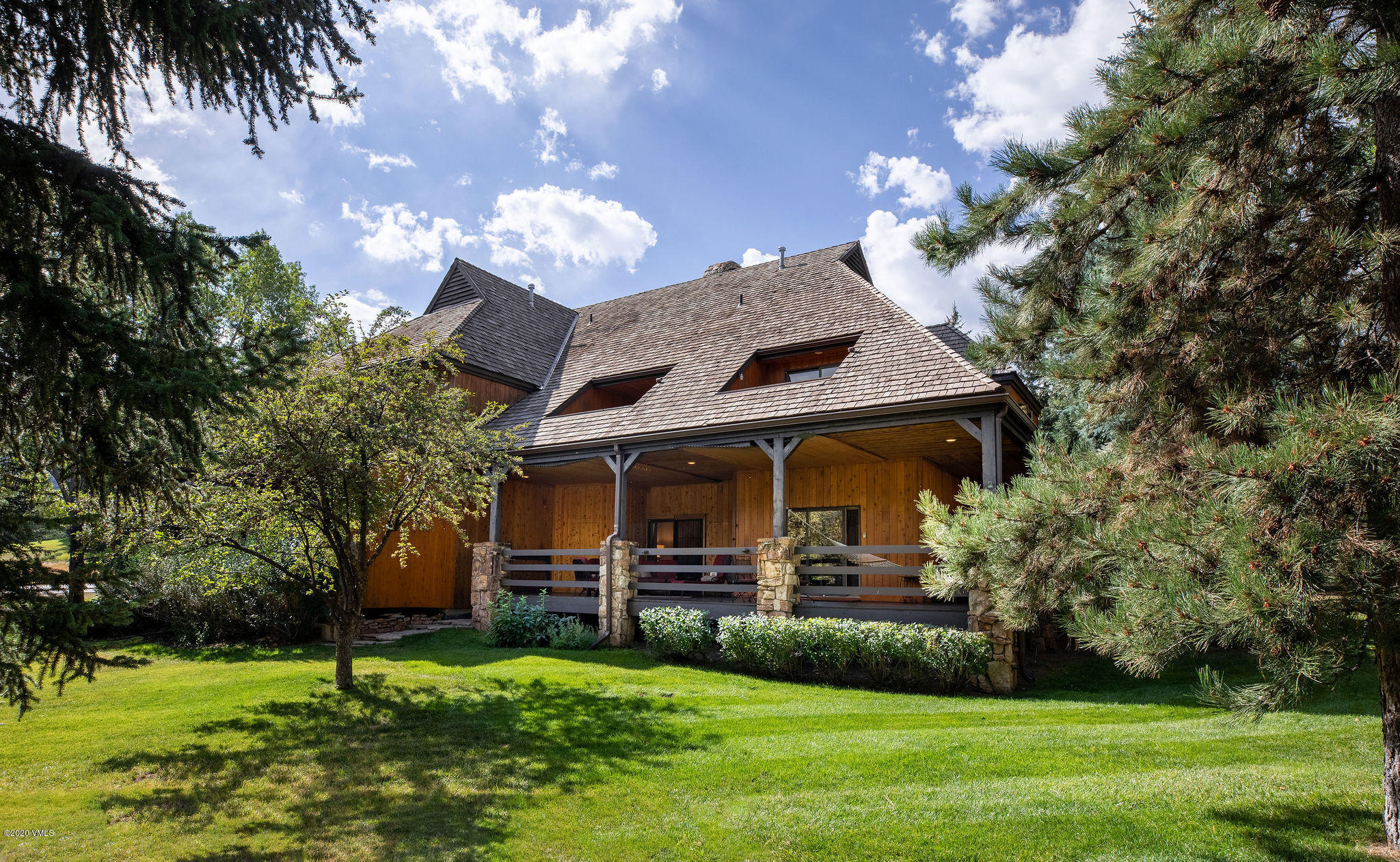10 Bachelor Gulch Road Beaver Creek, CO 81620 - Photo 6 of 19 a front view of a house with a yard table and chairs