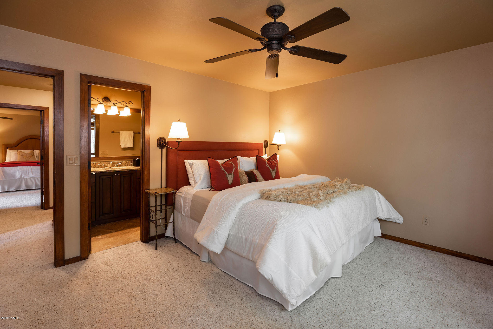 10 Bachelor Gulch Road Beaver Creek, CO 81620 - Photo 8 of 19 a bedroom with a bed and a chandelier