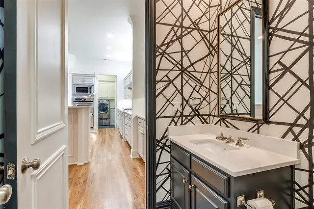 a view of a room with wooden floor and a flat screen tv