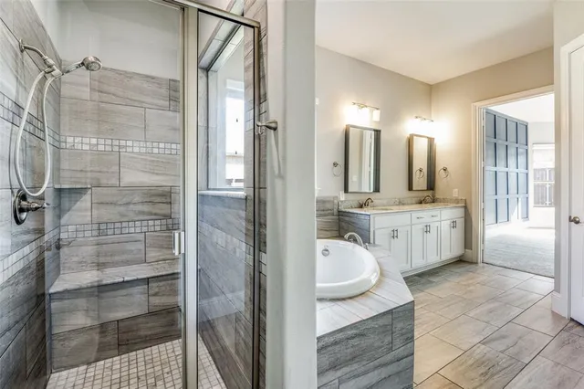 a bathroom with a double vanity sink a mirror and shower