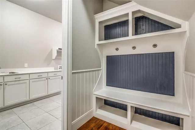 a kitchen with white cabinets and white appliances