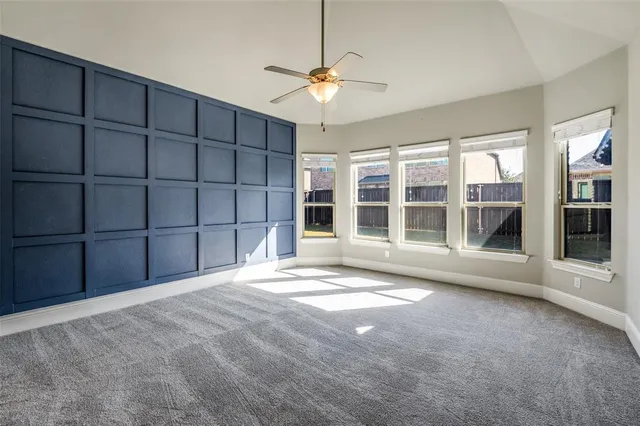 a view of a livingroom with a ceiling fan and window