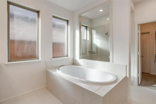 a bathroom with a bathtub and shower