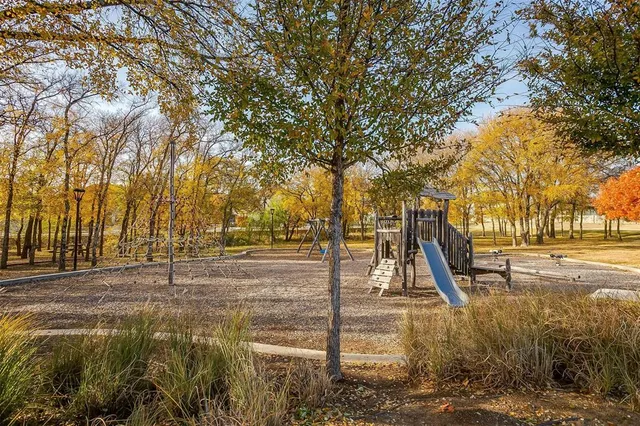 a backyard of a house with barbeque oven table and chairs