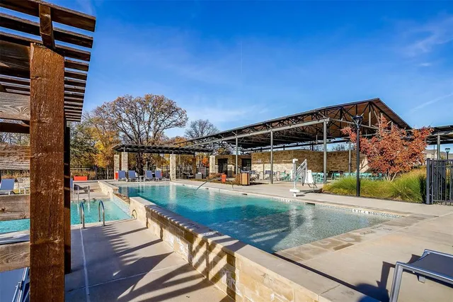 a view of a swimming pool with outdoor seating