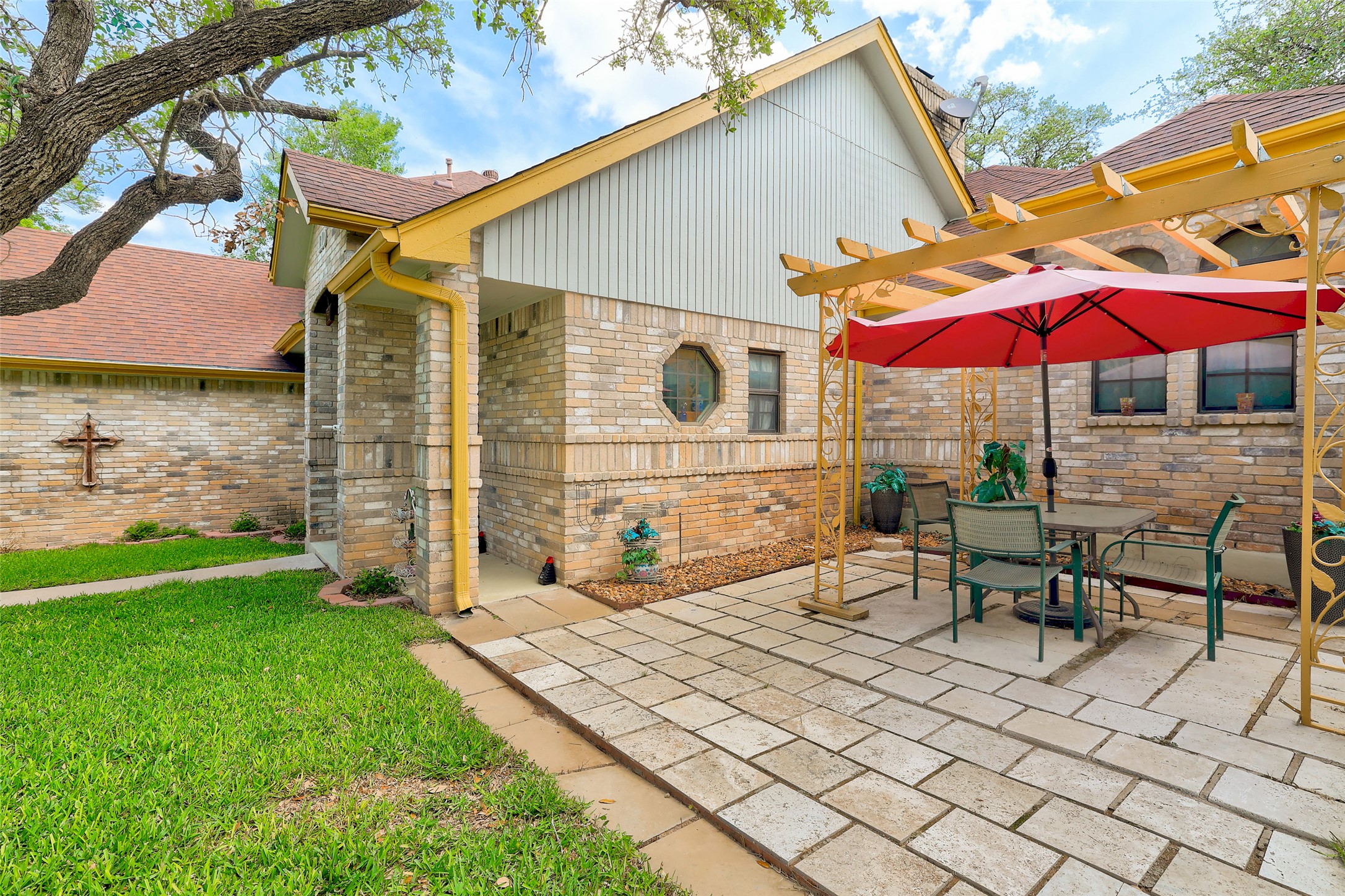 110 South Ridge Circle Georgetown, TX 78628 - Photo 3 of 37 Brick exterior with a gabled roofline and yellow trim accents