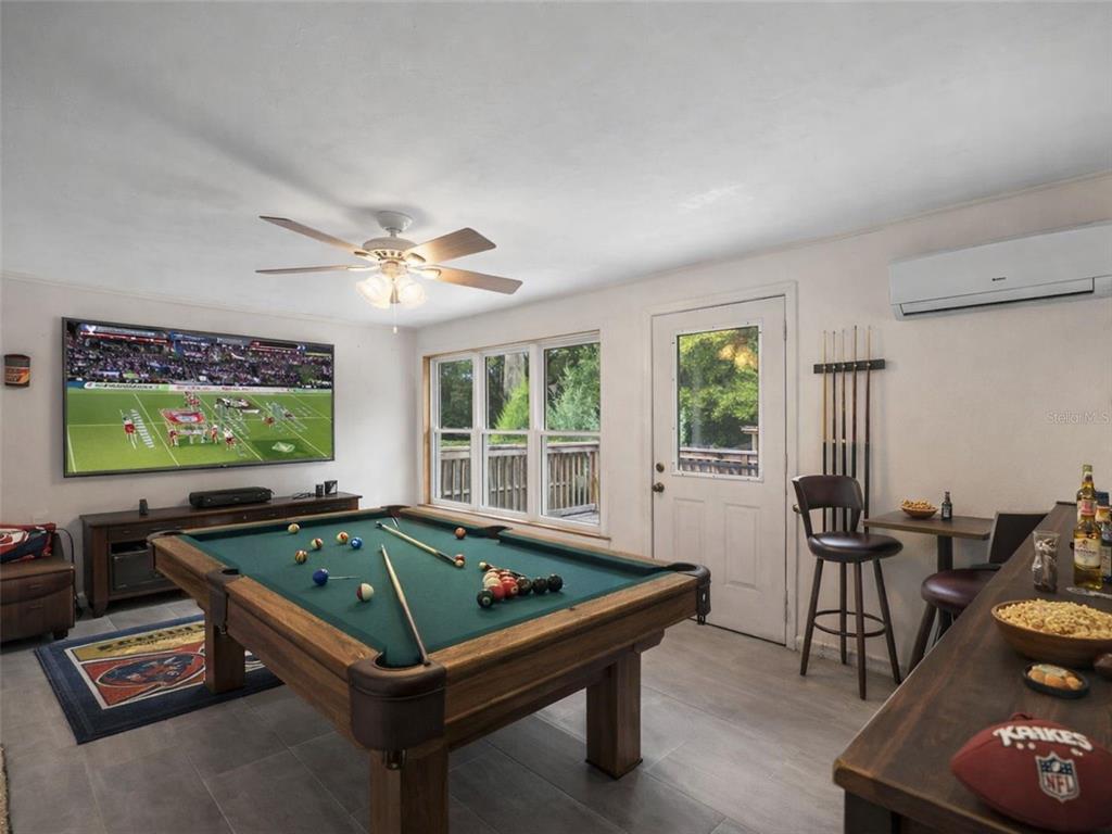 5915 Ave F McIntosh, FL 32664 - Photo 29 of 52 a room with furniture pool table flat screen tv and windows