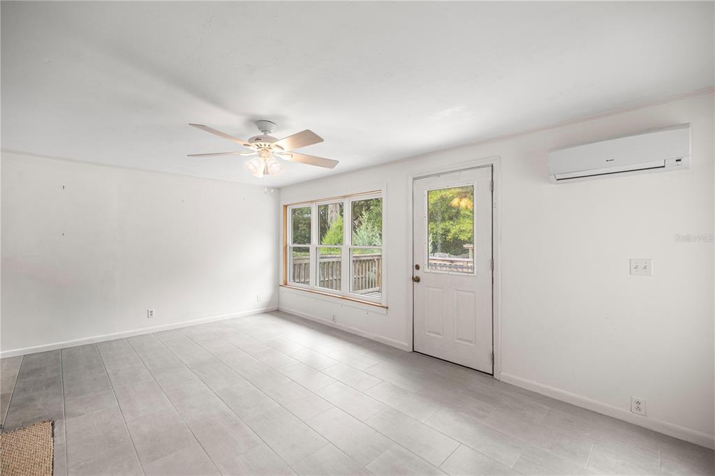 5915 Ave F McIntosh, FL 32664 - Photo 32 of 50 an empty room with windows and ceiling fan