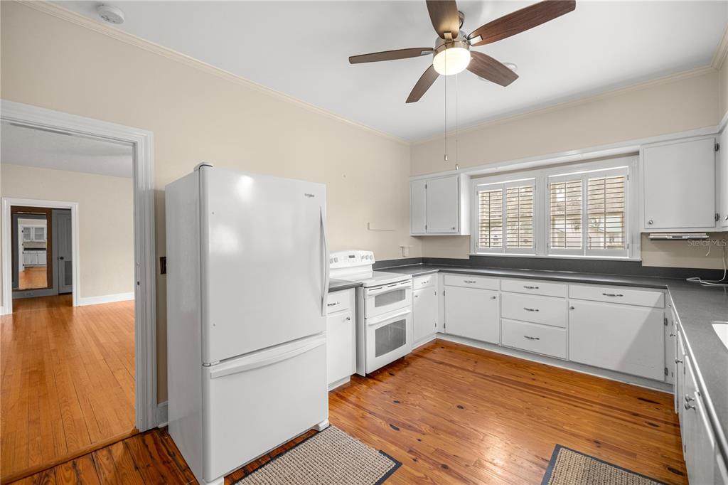 5915 Ave F McIntosh, FL 32664 - Photo 5 of 52 a kitchen with white cabinets and white appliances