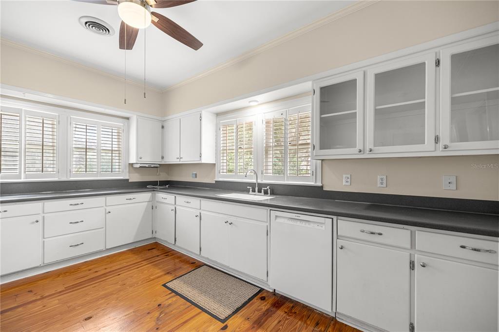 5915 Ave F McIntosh, FL 32664 - Photo 10 of 50 a kitchen with granite countertop white cabinets and window