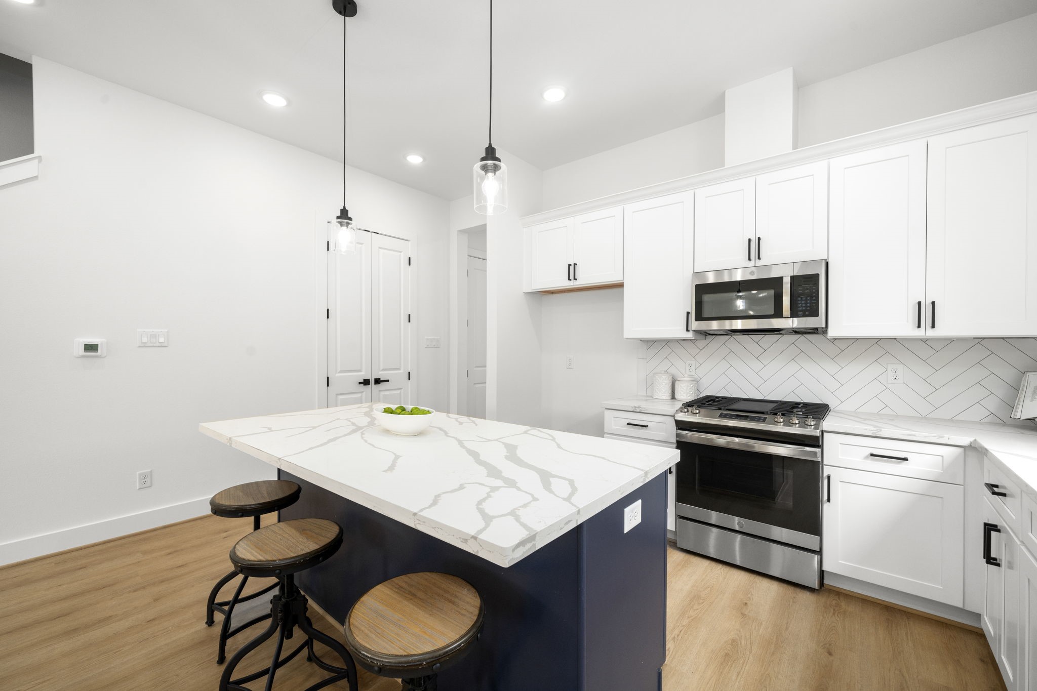 5514 Hardy Street Houston, TX 77009 - Photo 11 of 30 a kitchen with granite countertop a stove a sink and a microwave