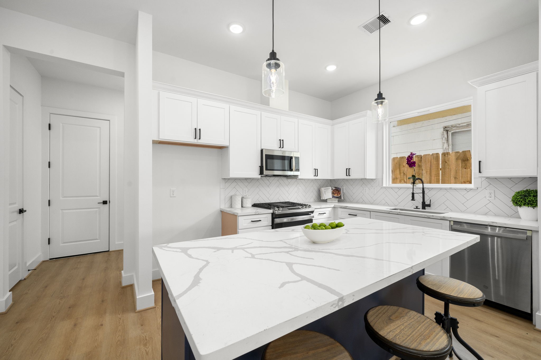 5514 Hardy Street Houston, TX 77009 - Photo 12 of 30 a kitchen with a table chairs stove and cabinets