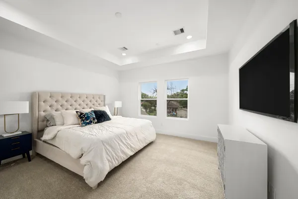 a bedroom with a bed and a flat screen tv