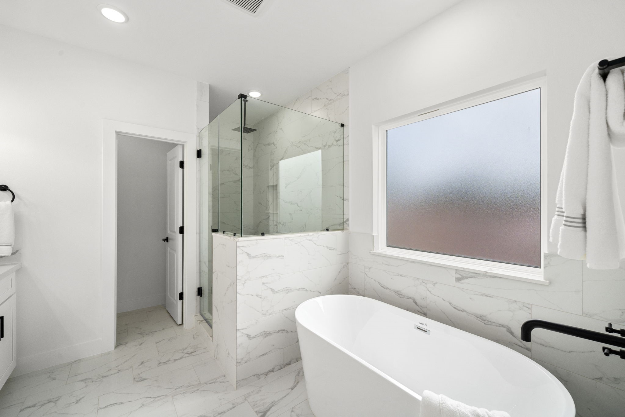 5514 Hardy Street Houston, TX 77009 - Photo 19 of 30 a bathroom with a tub a sink and a large mirror