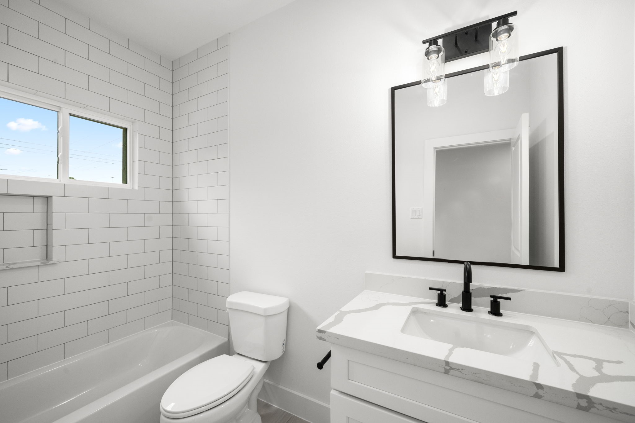 5514 Hardy Street Houston, TX 77009 - Photo 24 of 30 a bathroom with a toilet a sink a mirror and bathtub