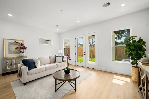 a living room with furniture and a potted plant