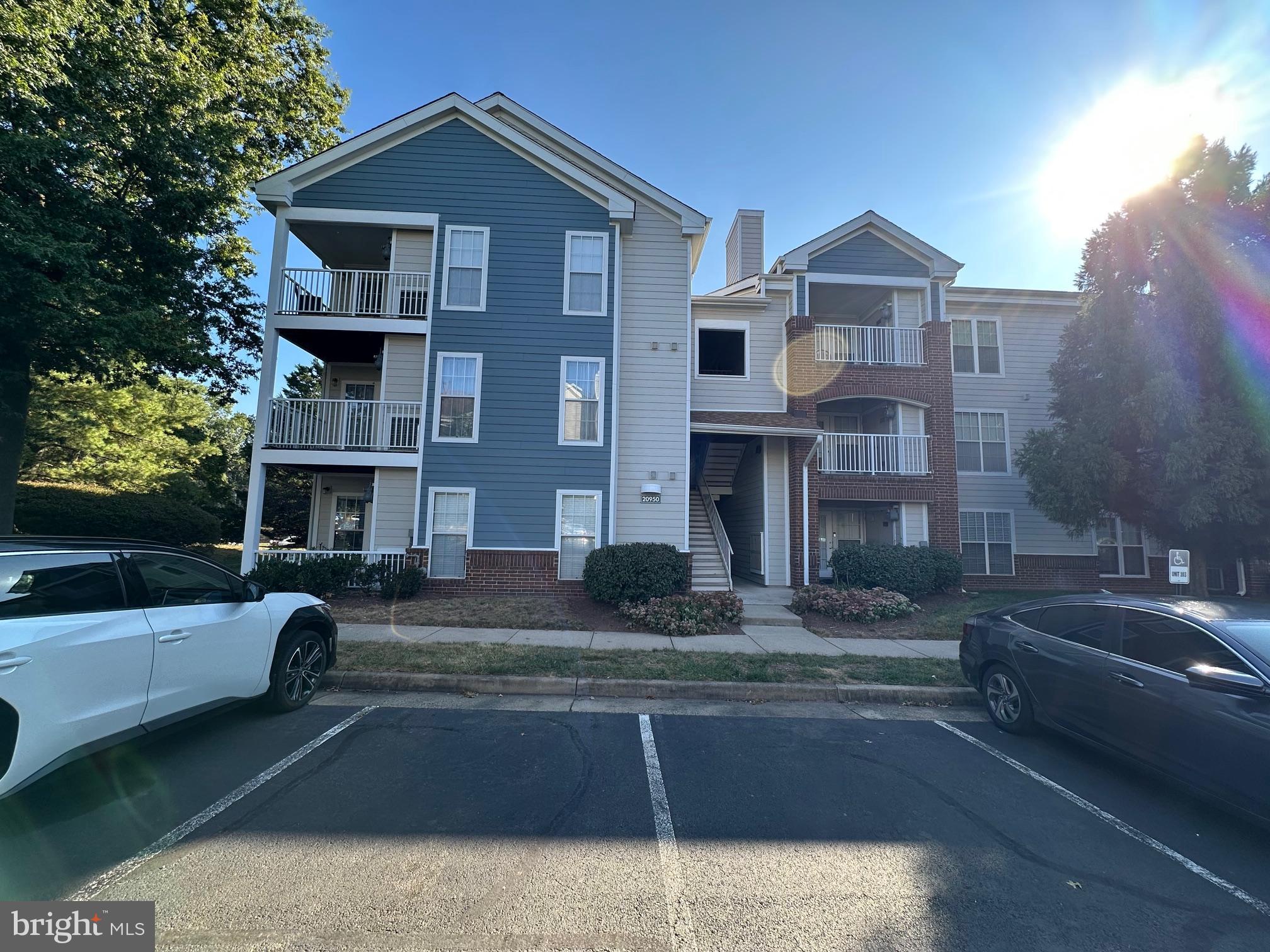 20950 Timber Ridge Terrace, Unit 201 Ashburn, VA 20147 - Photo 20 of 20 a front view of a house with swimming pool