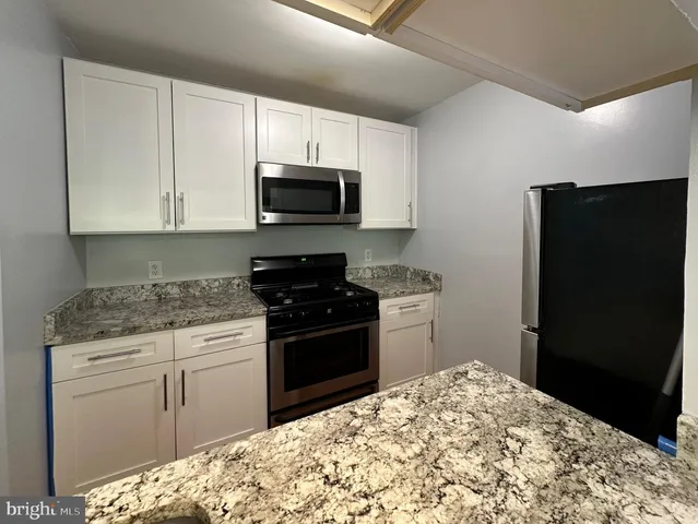 a kitchen with a sink stove and refrigerator