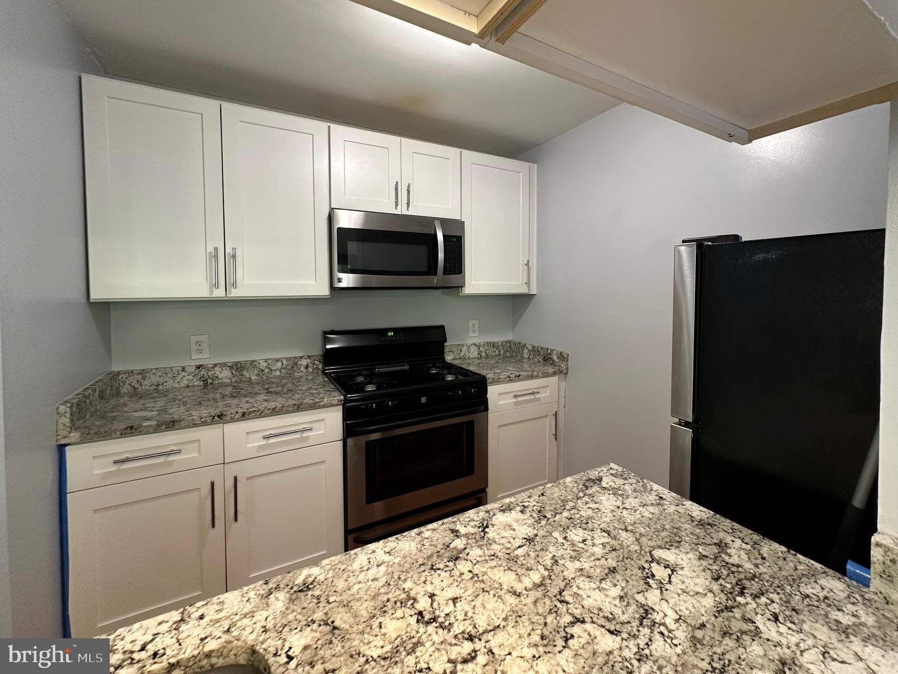 20950 Timber Ridge Terrace, Unit 201 Ashburn, VA 20147 - Photo 9 of 20 a kitchen with a sink stove and refrigerator