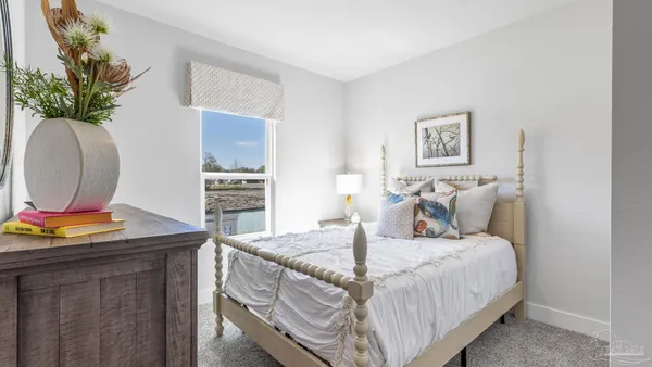 a bedroom with a bed and a mirror
