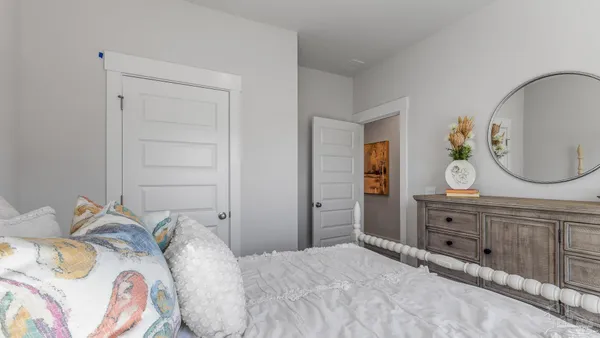 a bedroom with a bed and a dresser