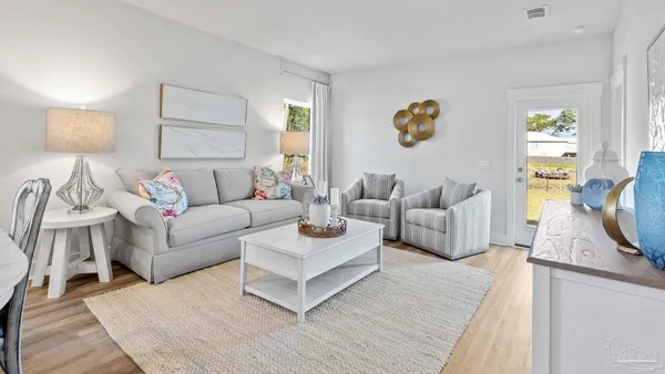 a living room with furniture and a large window