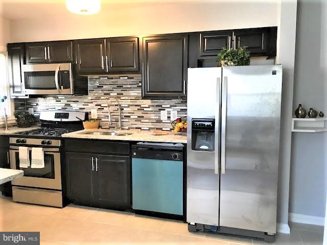 4537 Marble Hall Road Baltimore, MD 21239 - Photo 4 of 14 a kitchen with stainless steel appliances kitchen island granite countertop a refrigerator oven a sink and dishwasher