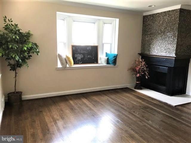 4537 Marble Hall Road Baltimore, MD 21239 - Photo 5 of 14 a view of an empty room with wooden floor and a window