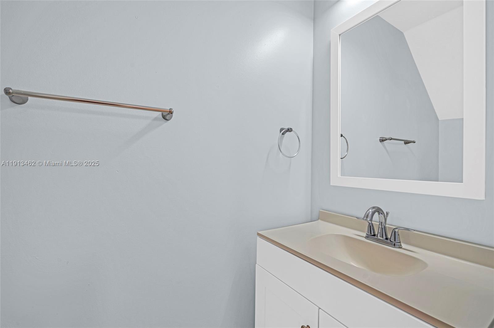 3197 Southwest 128th Way, Unit 135 Miramar, FL 33027 - Photo 15 of 35 a bathroom with a sink and a mirror