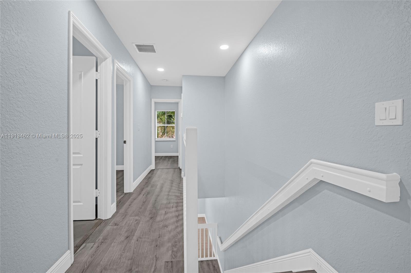 3197 Southwest 128th Way, Unit 135 Miramar, FL 33027 - Photo 18 of 35 a view of a hallway with wooden floor