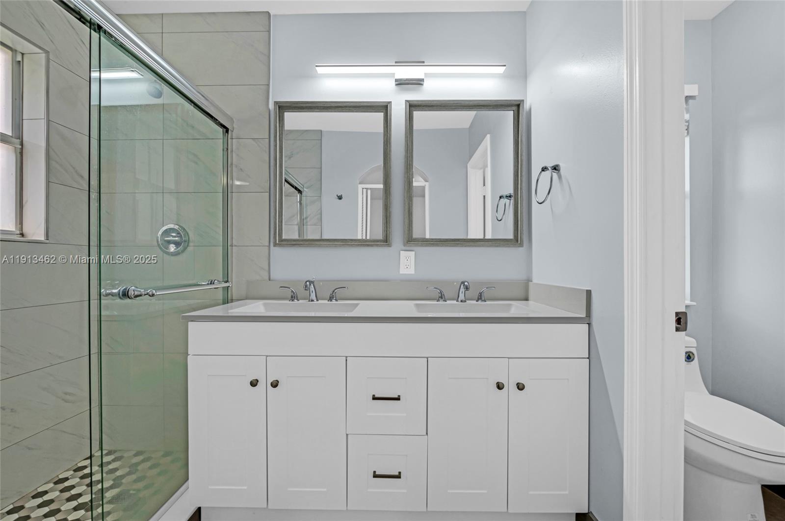 3197 Southwest 128th Way, Unit 135 Miramar, FL 33027 - Photo 20 of 35 a bathroom with a granite countertop sink mirror and double