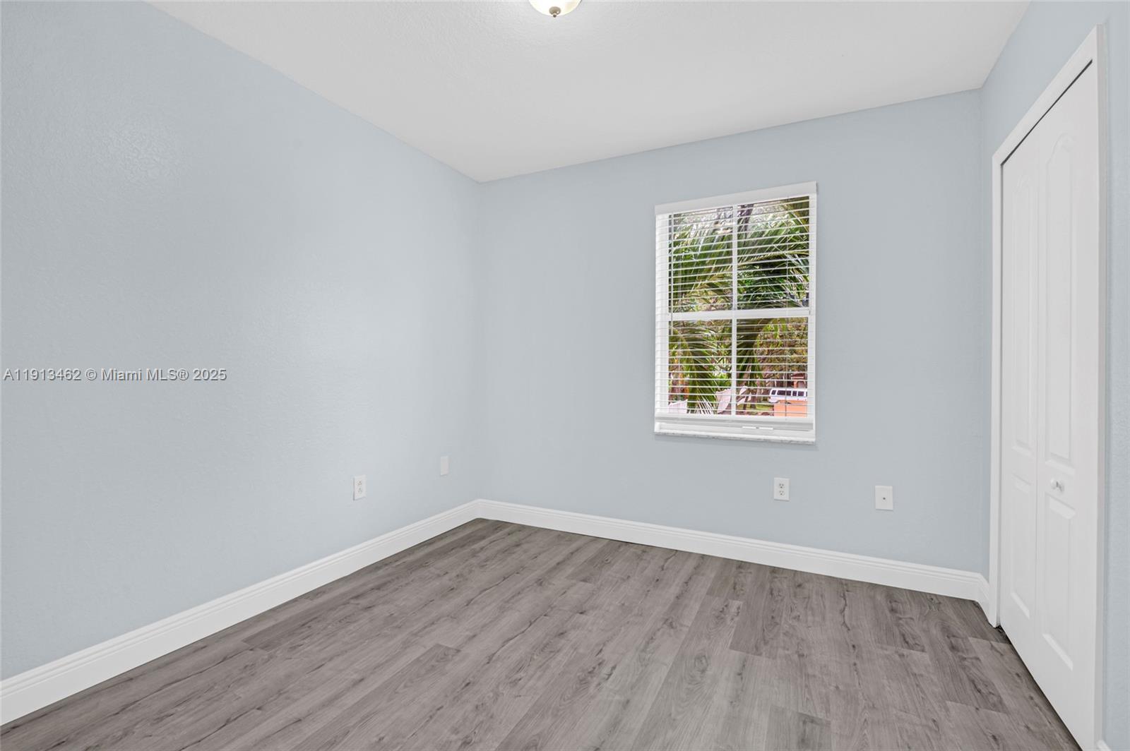 3197 Southwest 128th Way, Unit 135 Miramar, FL 33027 - Photo 24 of 35 wooden floor in an empty room with a window