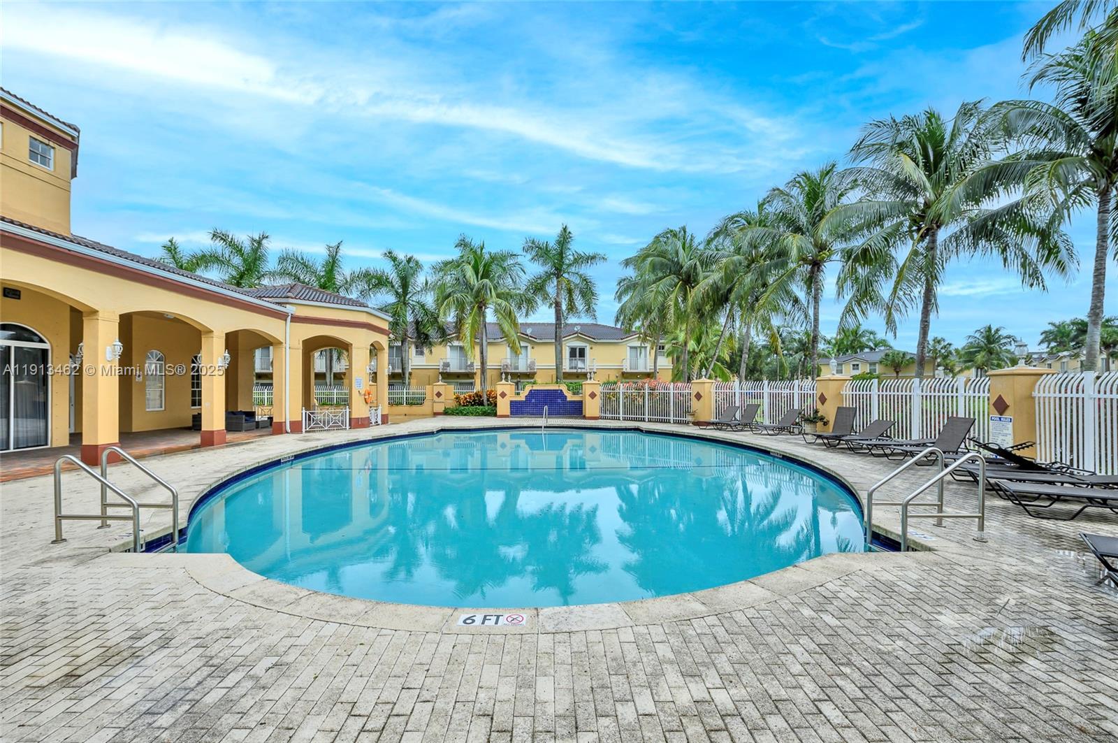 3197 Southwest 128th Way, Unit 135 Miramar, FL 33027 - Photo 26 of 35 a view of a swimming pool with chair and table