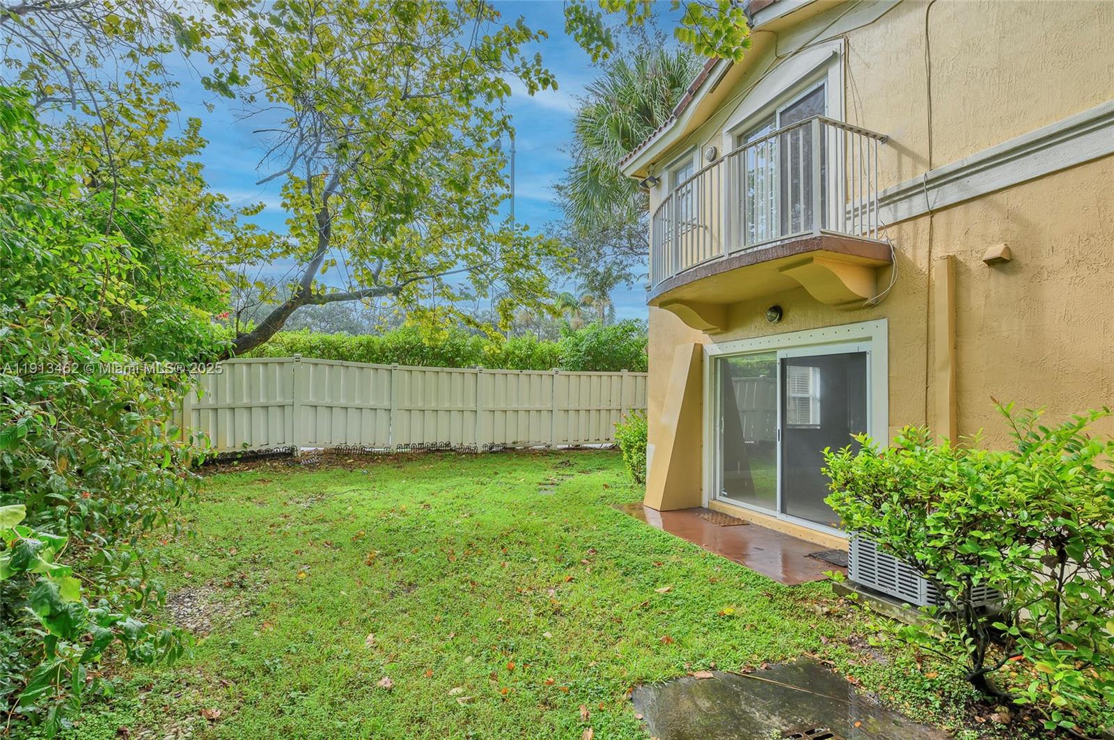 3197 Southwest 128th Way, Unit 135 Miramar, FL 33027 - Photo 6 of 35 a view of a house with a small yard and wooden fence