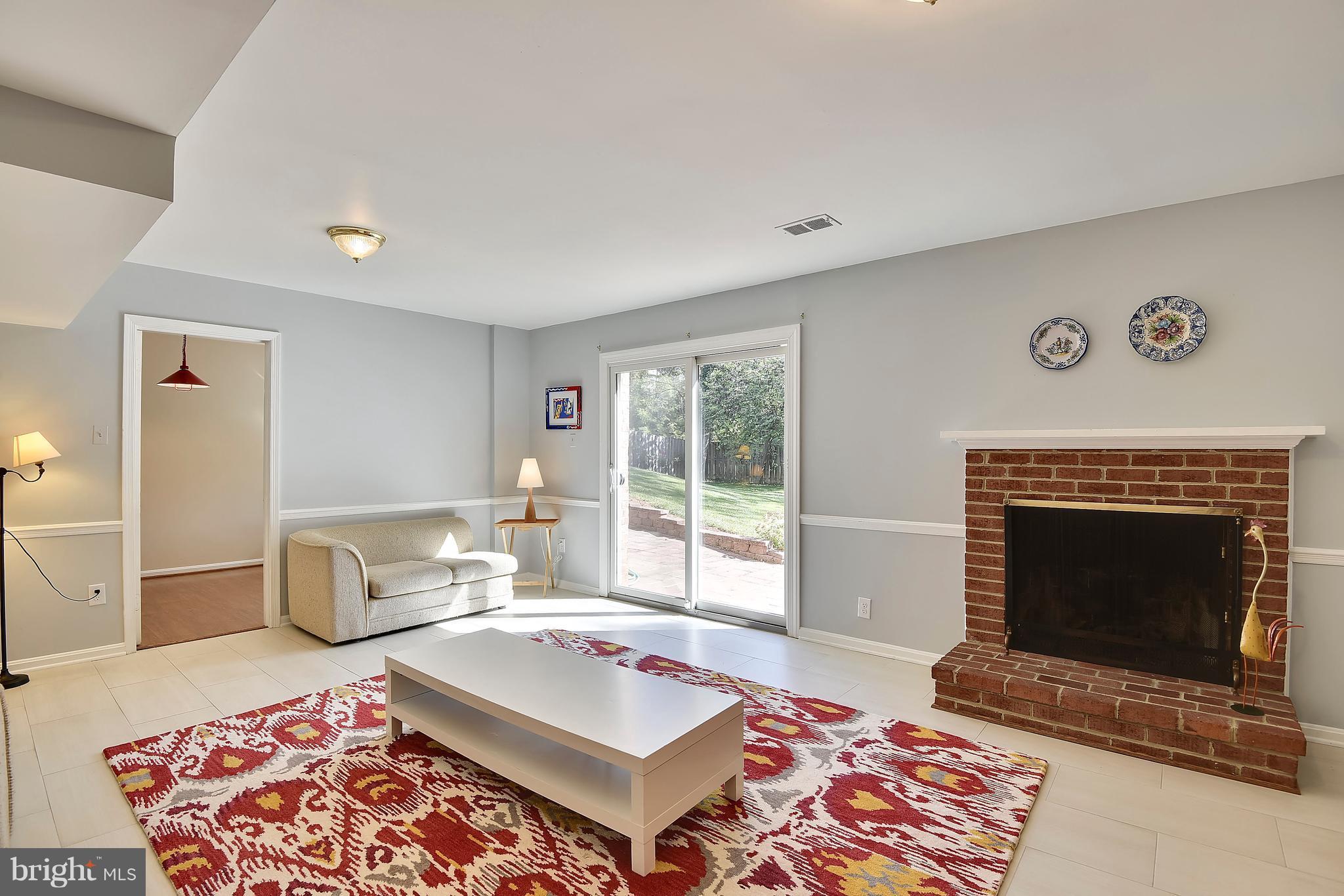 9 Treworthy Road Gaithersburg, MD 20878 - Photo 23 of 30 Rec Room w/ a fireplace for cozy evenings