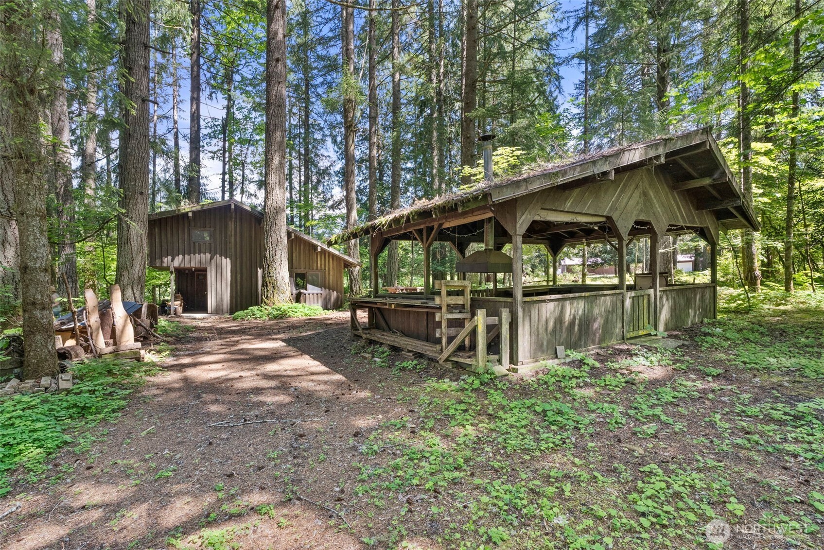 155 Bonell Road Randle, WA 98377 - Photo 34 of 38 a backyard of a house with lots of green space and fountain