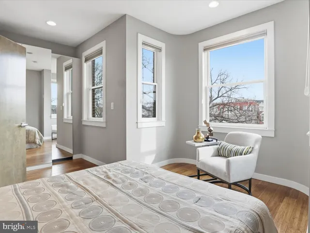 a bedroom with a bed and a couch