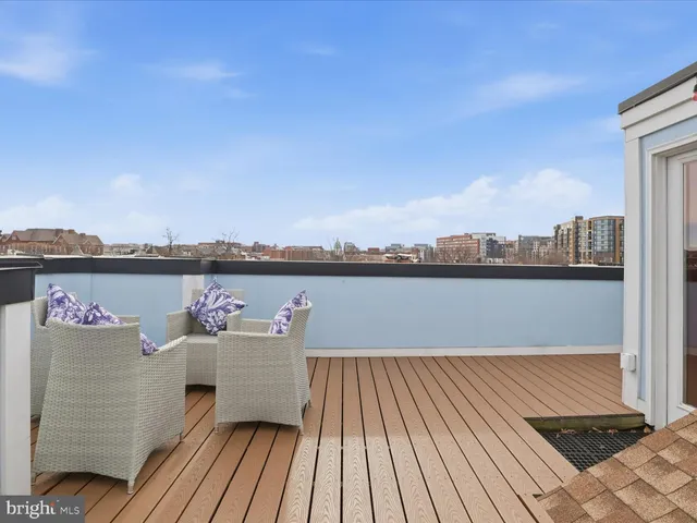 a view of a balcony with wooden floor and city view
