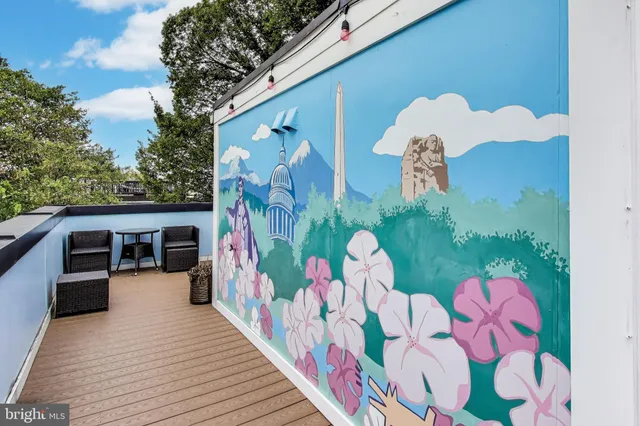 a bathroom with a sink mirror and clock on th wall