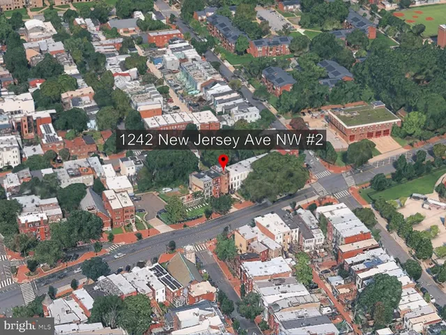 a street sign on a sidewalk next to a road