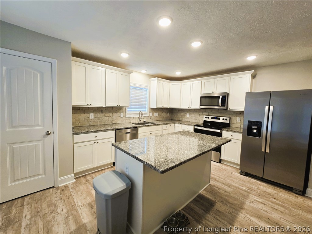 422 Mitchell Farm Road Goldsboro, NC 27530 - Photo 19 of 28 a kitchen with a refrigerator sink and cabinets