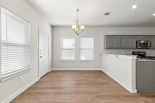 a view of a kitchen with microwave and cabinets