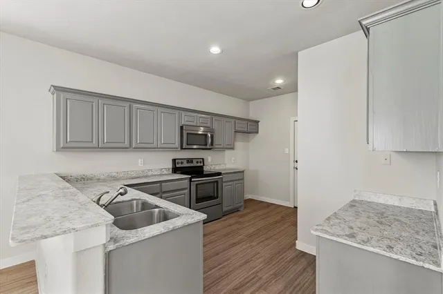 a kitchen that has a sink and a stove in it