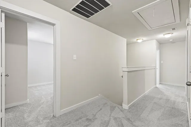 an empty room with white walls and entryway