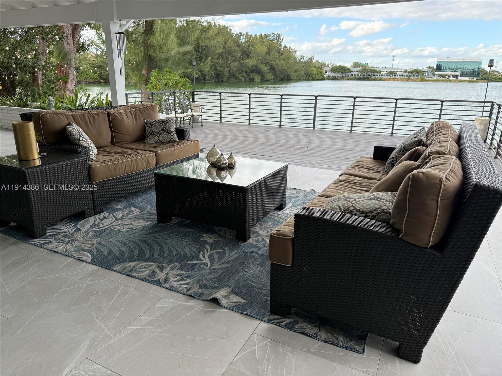 7521 Southwest 56th Street Miami, FL 33155 - Photo 14 of 34 a view of roof deck with couches and wooden floor