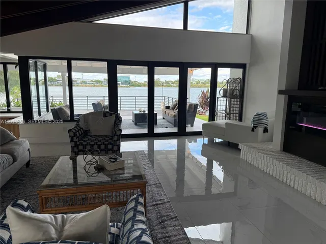 a living room with furniture and floor to ceiling windows